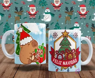 Par de tazas de sublimación con temática navideña. Una taza presenta un capibara con gorro de Papá Noel junto a un árbol de Navidad. La segunda taza exhibe un emblema festivo con un árbol y regalos bajo el texto 'Feliz Navidad'.