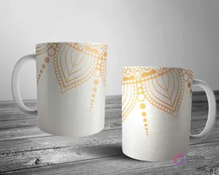 Dos tazas blancas con un elegante diseño de mandala en oro metálico sobre un fondo crema suave, ideal para un estilo sutil y refinado.