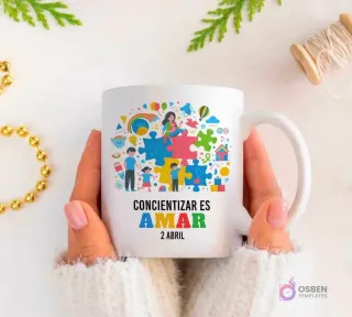 Manos sujetando una taza blanca con una ilustración familiar y piezas de puzzle, con la frase 'CONCIENTIZAR ES AMAR 2 ABRIL'.