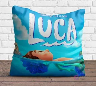 Cojín cuadrado sublimado con el personaje Luca de Disney Pixar en forma humana emergiendo del agua, con el logo, sobre un fondo azul claro.