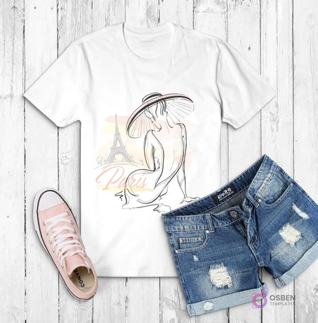 Polera blanca con dibujo de una mujer sentada de espaldas con sombrero de ala ancha, y la Torre Eiffel de fondo con acuarela