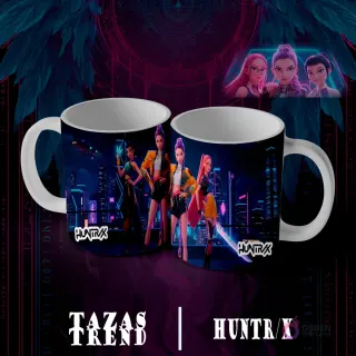 Dos tazas blancas con diseño de sublimación Huntrix Demon Hunter N°7, mostrando cuatro personajes femeninos animados en atuendos de moda, paradas frente a un horizonte urbano nocturno iluminado con neones.