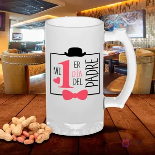 Chopero esmerilado con diseño 'Mi 1er Día del Padre' y elementos de sombrero, bigote y moño rosa, sobre mesa de madera con cacahuetes, fondo de bar. Plantilla para primer Día del Padre.