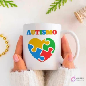 Manos sujetando una taza blanca con la palabra 'AUTISMO' y un gran corazón formado por cuatro piezas de puzzle de colores primarios.