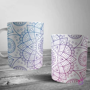 Dos tazas blancas con un diseño de mandala intrincado de contorno en un degradado de azul a morado sobre un fondo blanco puro.