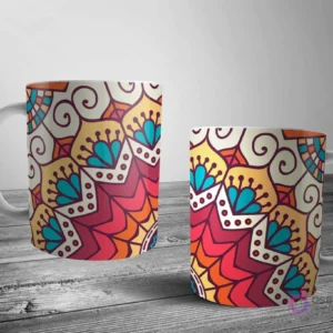 Dos tazas blancas con un diseño de mandala rico y terroso, con elementos florales y geométricos en tonos cálidos de naranja, rojo, amarillo y teal.