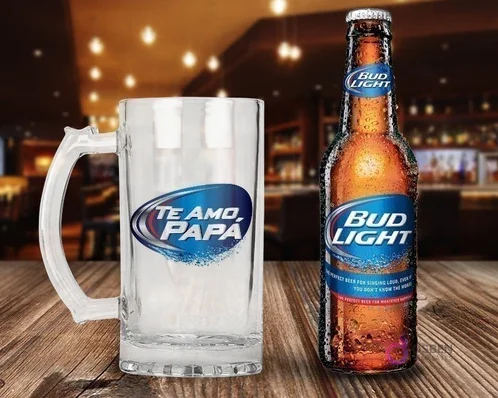 Maqueta de shopero de cristal sublimado con diseño 'Te Amo, Papá' (estilo Bud Light) junto a una botella de Cerveza Bud Light Maqueta de shopero de cristal sublimado con diseño 'Te Amo, Papá' (estilo Bud Light) junto a una botella de Cerveza Bud Light