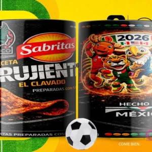 Par de tazas blancas sublimadas con diseños de Sabritas Crujiente El Clavado y las mascotas del Mundial 2026, con un fondo amarillo de campo de fútbol