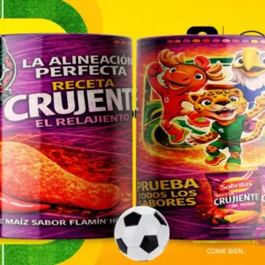 Par de tazas blancas sublimadas con diseños de Sabritas Crujiente Flamin' Hot y las mascotas del Mundial 2026, con un fondo amarillo de campo de fútbol