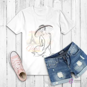 Polera blanca con dibujo de una mujer sentada de espaldas con sombrero de ala ancha, y la Torre Eiffel de fondo con acuarela