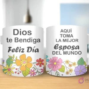 Taza de sublimación con diseño floral, texto 'Dios te Bendiga Feliz Día' y 'AQUÍ TOMA LA MEJOR Esposa DEL MUNDO' con asa blanca.