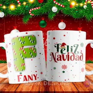 Taza sublimada con la letra F mayúscula en verde y blanco con patrones de bastones de caramelo, junto al nombre 'FANY' y al reverso 'Feliz Navidad' con estrellas y copos de nieve.